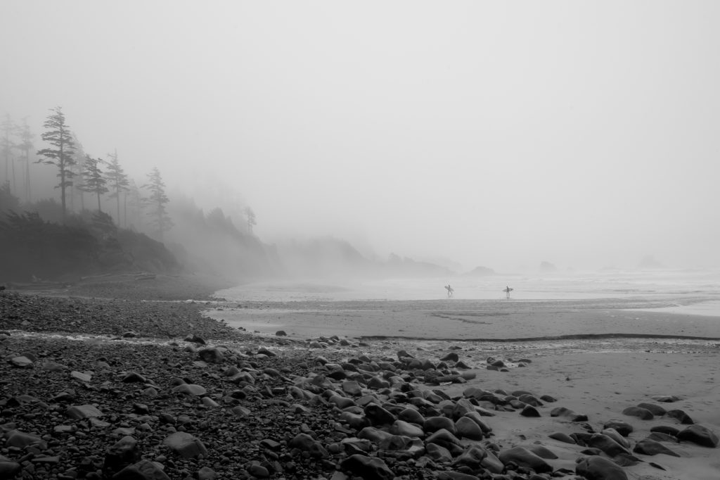Foggy Day at the Beach with Surfers